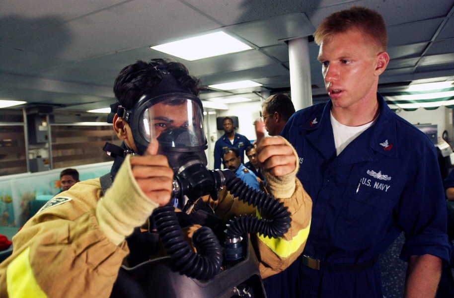 US Navy 020924-N-4309A-031 Damage Controlman 2nd Class Brian Adams assists Pakistani Lt. Affan Anis, assigned to the Tariq-class Pakistani frigate Tippu Sultan (D 185)