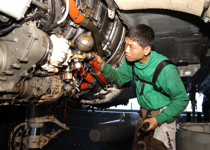 US Navy 020930-N-6817C-003 A Sailor installs the engine on an F-14D ^ldquo,Tomcat.^rdquo
