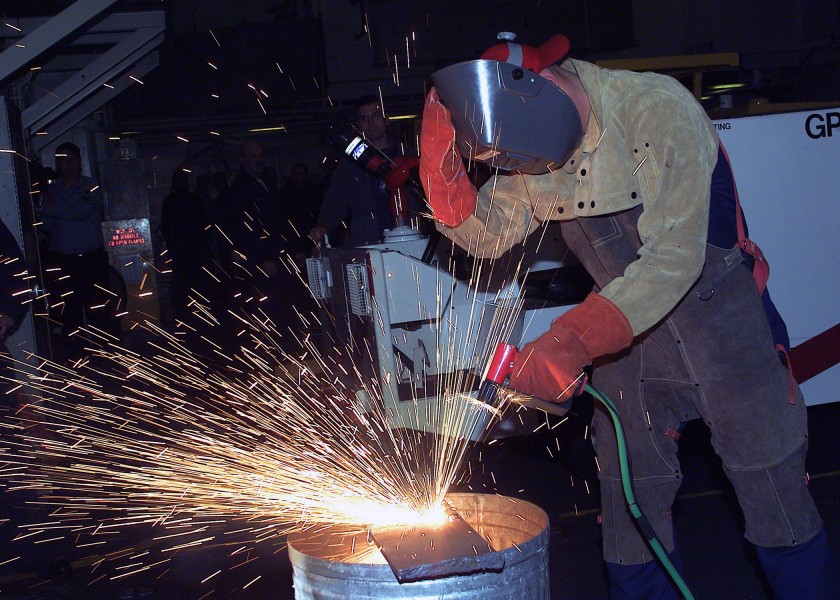 US Navy 021116-N-1126D-031 Damage Controlman uses a portable exothermic cutting unit 