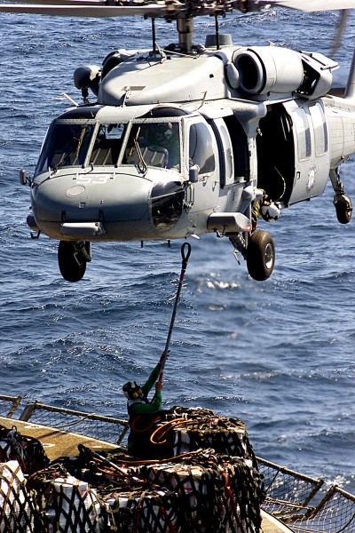 US Navy 021208-N-9977R-002 A U.S. Navy MH-60S Knighthawk helicopter hovers over the deck of the Military Sealift Command auxiliary supply ship USNS San Jose (T-AFS-7) 