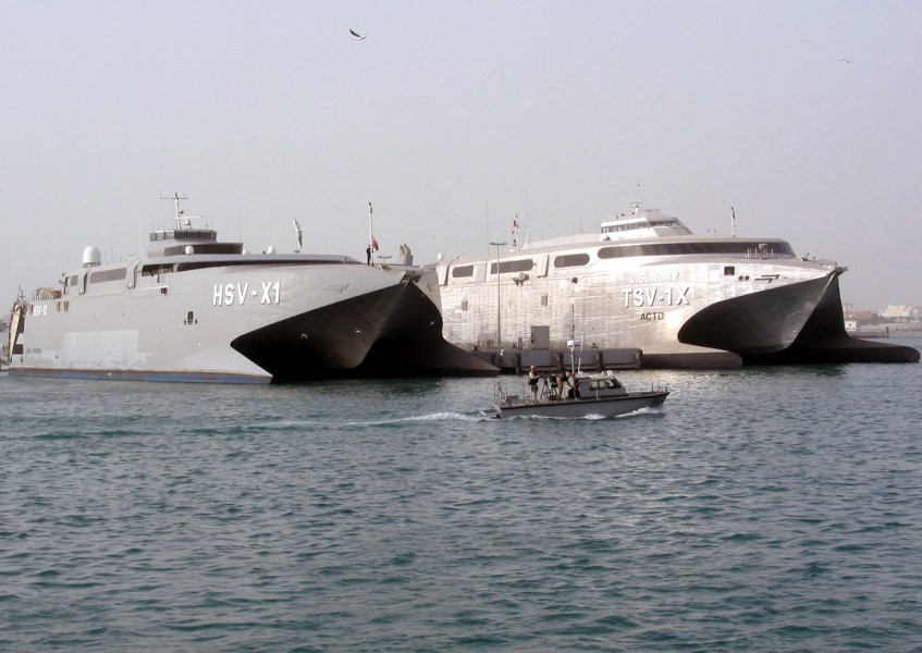 US Navy 030225-N-1050K-001 Sealift vehicles belonging to the U.S. Navy and U.S. Army sit together pier side under the watchful eye of both the U.S. and Kuwaiti harbor patrol
