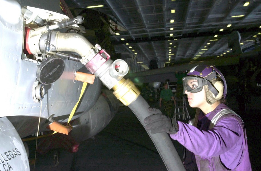 US Navy 030425-N-1577S-001 Airman Lorena Tiscareno from Mesa, Ariz., refuels an F-18