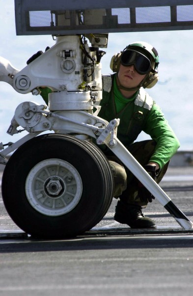 US Navy 030425-N-9319H-005 A crewmember inspects the launch bar before giving the thumbs up