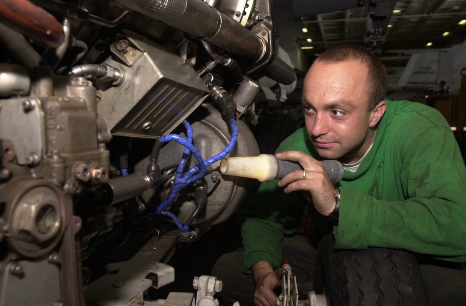 US Navy 030601-N-2143T-001 Aviation Machinist^rsquo,s Mate 3rd Class Bart Szczepanski from Lemoore, Calif., inspects an engine