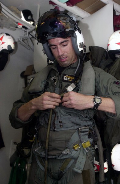 US Navy 030617-N-2385R-002 Lt. Christopher Papaioanu removes his flight gear in the paraloft aboard USS Nimitz (CVN 68)