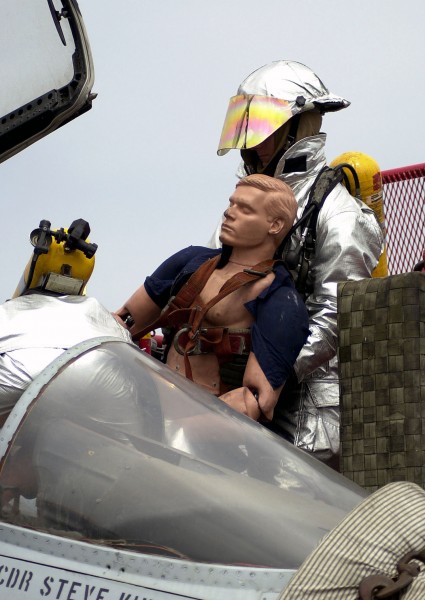 US Navy 030708-N-6213R-104 Crash and salvage personnel pull a simulated injured pilot out of the cockpit during training exercises on the flight deck aboard USS John C. Stennis (CVN 74)