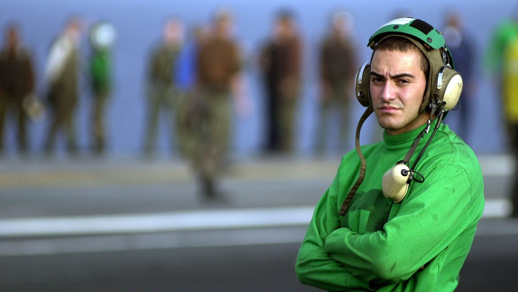 US Navy 030729-N-6213R-443 Airman Eugene Streeper mans the sound-powered phones on the flight deck of USS John C. Stennis (CVN 74)