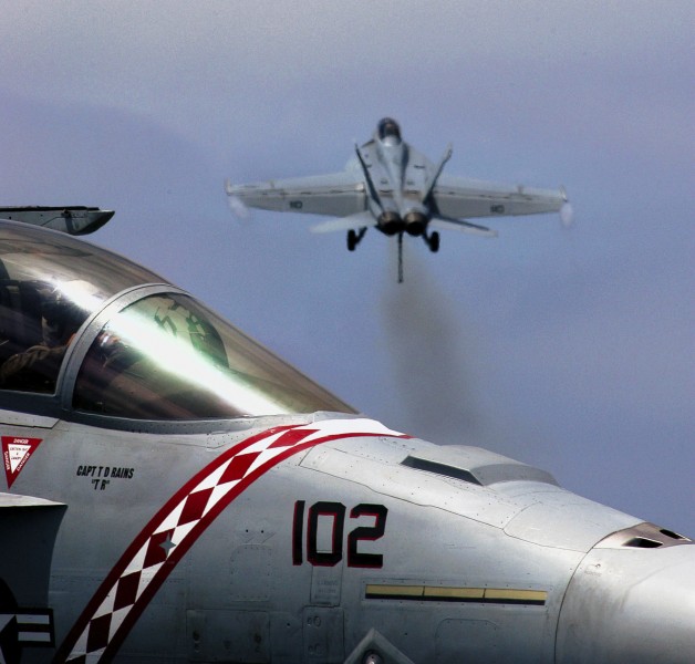 US Navy 030807-N-1573O-049 An F-A-18F Super Hornet lifts off the deck of USS John C. Stennis (CVN 74) as another Super Hornet is seen in the foreground