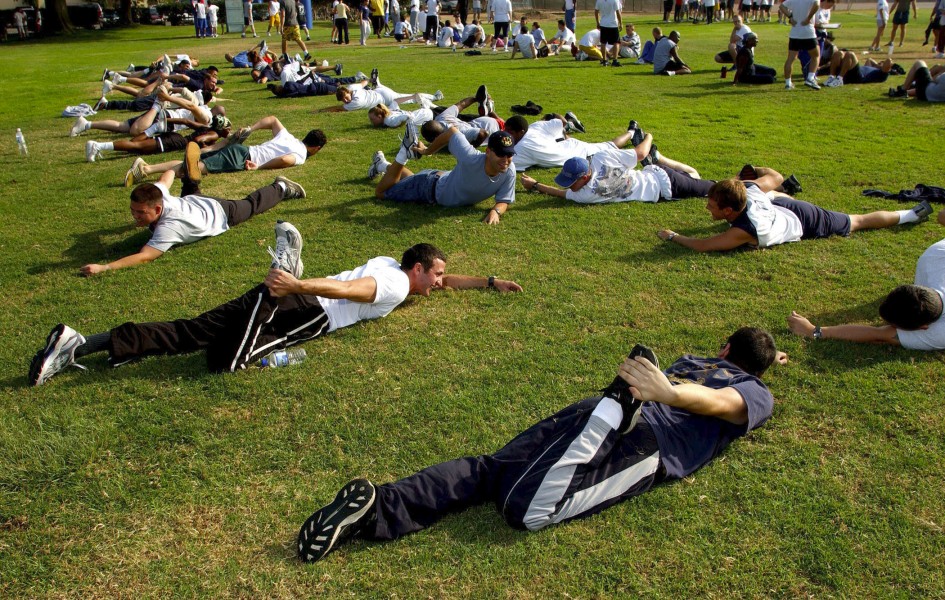US Navy 031008-N-6213R-069 Sailors from USS John C. Stennis (CVN 74) stretch out before a command Physical Fitness Assessment (PFA)
