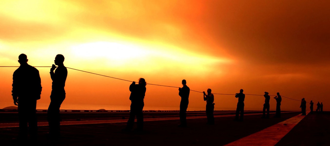 US Navy 031026-N-9769P-054 Flight deck personal aboard USS John C. Stennis (CVN 74) act as safety observers during steam catapult testing, under a cloud of smoke from nearby burning wildfires
