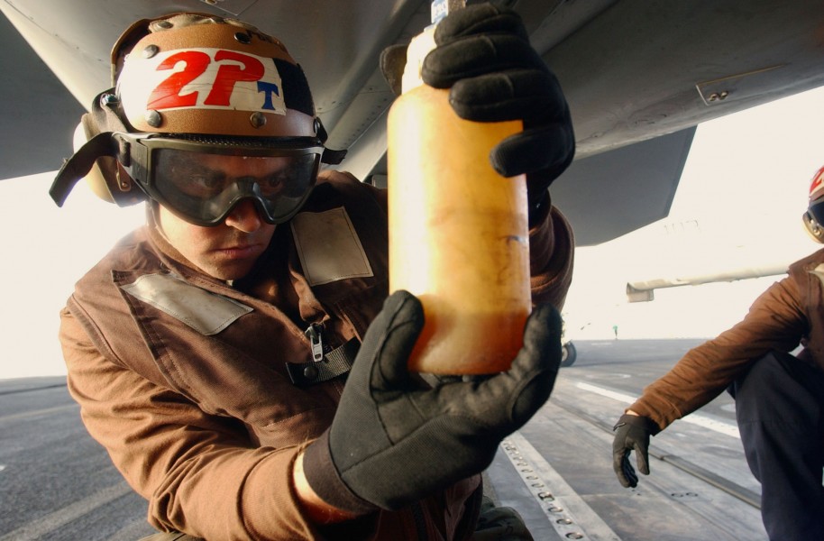 US Navy 031101-N-4768W-141 Aviation Electronics Technician Airman Cole Bailey, from Aberdeen, Wash., inspects F-A-18 Super Hornet engine oil on the flight deck of USS John C. Stennis (CVN 74)