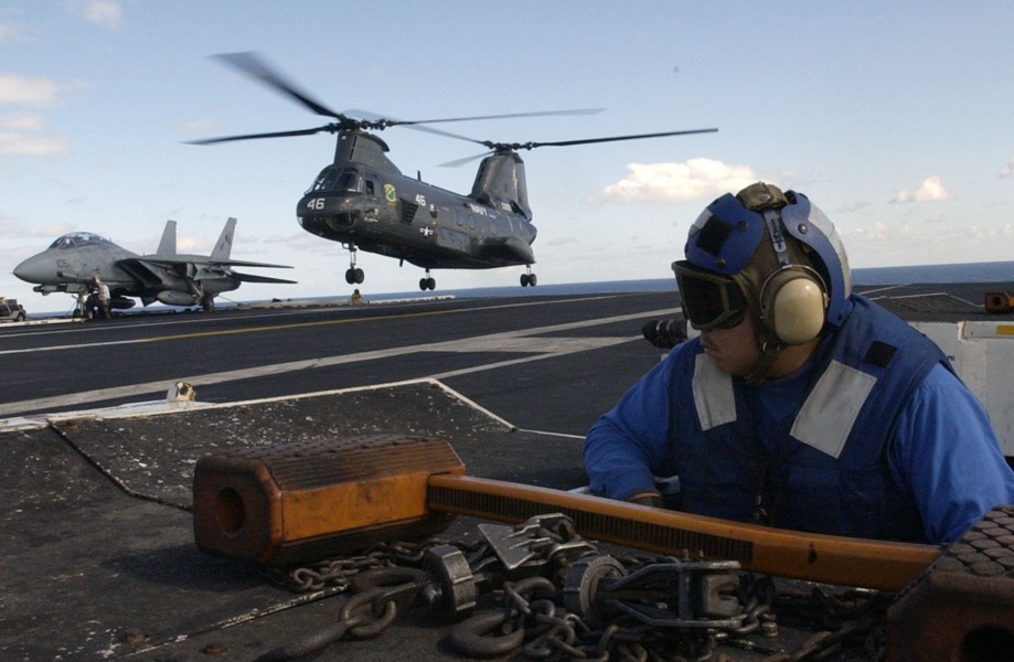 US Navy 031103-N-6713R-064 Aviation Boatswain's Mate Airman Thomas Brehm observes the landing of a CH-46 Sea Knight