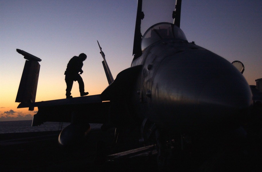 US Navy 031103-N-7732W-139 A plane captain makes a safety inspection of an F-A-18C Hornet