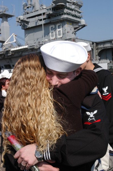 US Navy 031105-N-1356A-004 Damage Controlman 3rd Class Thomas Howard embraces his wife