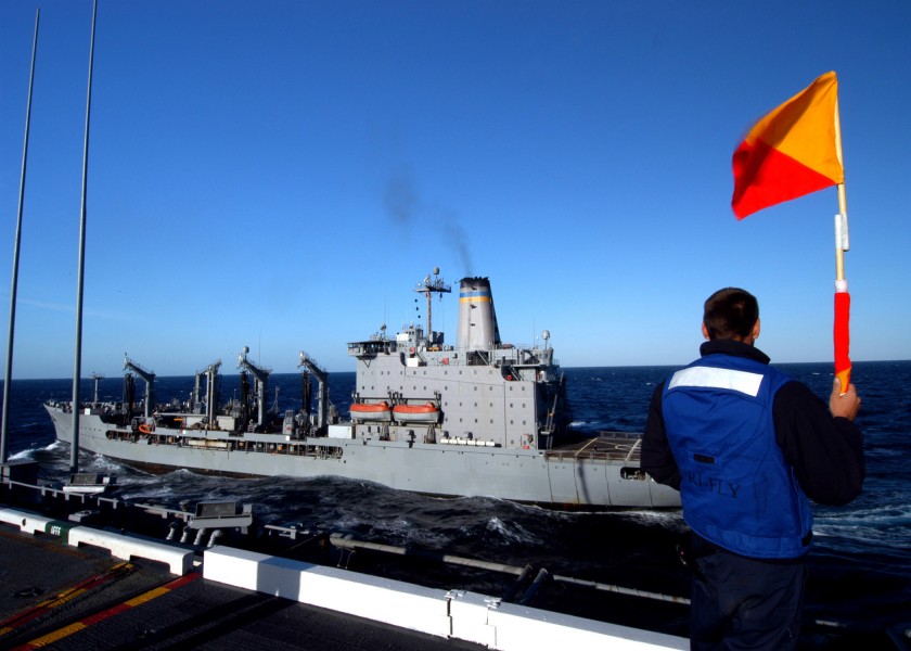 US Navy 031114-N-4190W-003 Signalman 3rd Class Ian Leimbach waves in the Military Sealift Command