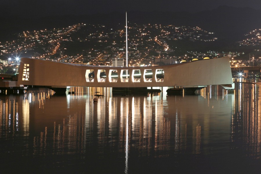 US Navy 031206-N-3228G-001 The USS Arizona Memorial is bathed in light from a neighboring community the night before the 62nd Commemoration of the Dec. 7, 1941 attack 