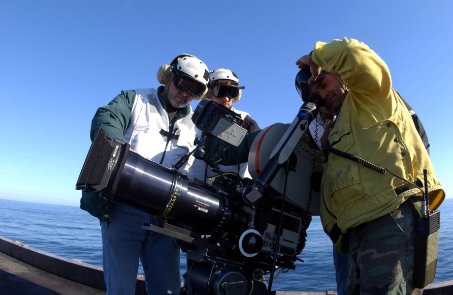 US Navy 040129-N-0905V-021 Members of Columbia Pictures visual effects unit offer Aviation Boatswain^rsquo,s Mate Alberto Melendez a look into the viewfinder of their video camera