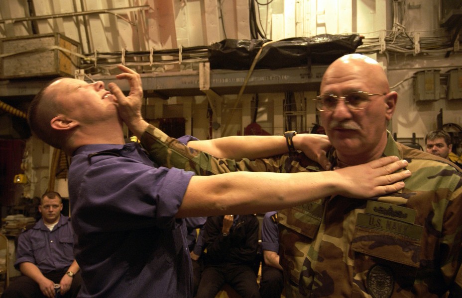 US Navy 040212-N-5319A-019 Master Chief Master-at-Arms Gregory Ciaccio, Ship^rsquo,s Security Chief aboard USS George Washington (CVN 73), holds self-defense training