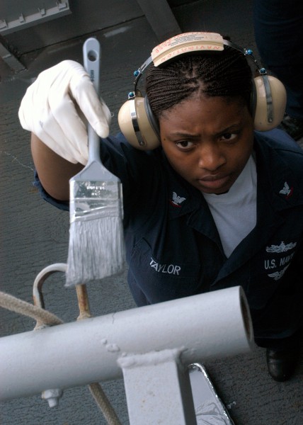 US Navy 040420-N-4669B-002 Signalman 3rd Class April Taylor, of Kinston, N.C., retouches the ^ldquo,haze gray^rdquo, paint on the signal bridge