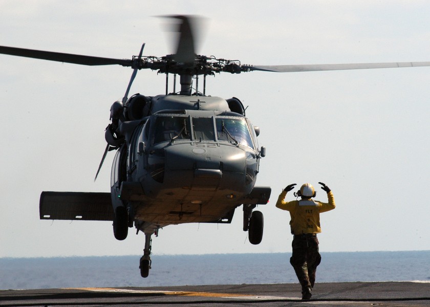 US Navy 040423-N-9742R-004 Aviation Boatswain's Mate 3rd Class Ifoma Givens, of Philadelphia, Pa., directs an MH-60S Knighthawk