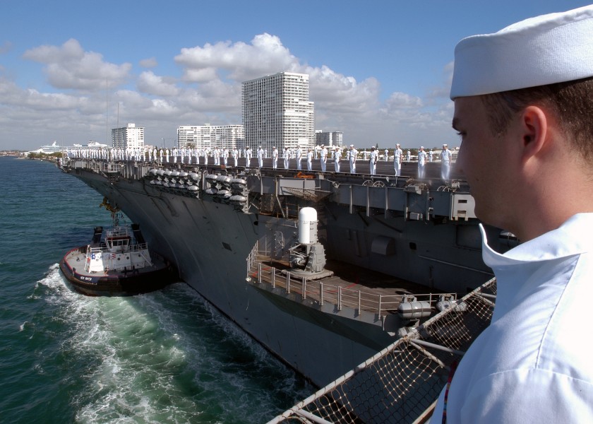 US Navy 040426-N-9742R-001 USS Enterprise (CVN-65) Sailors man the rails while commercial tugs assist the aircraft carrier into Ft. Lauderdale, Fla