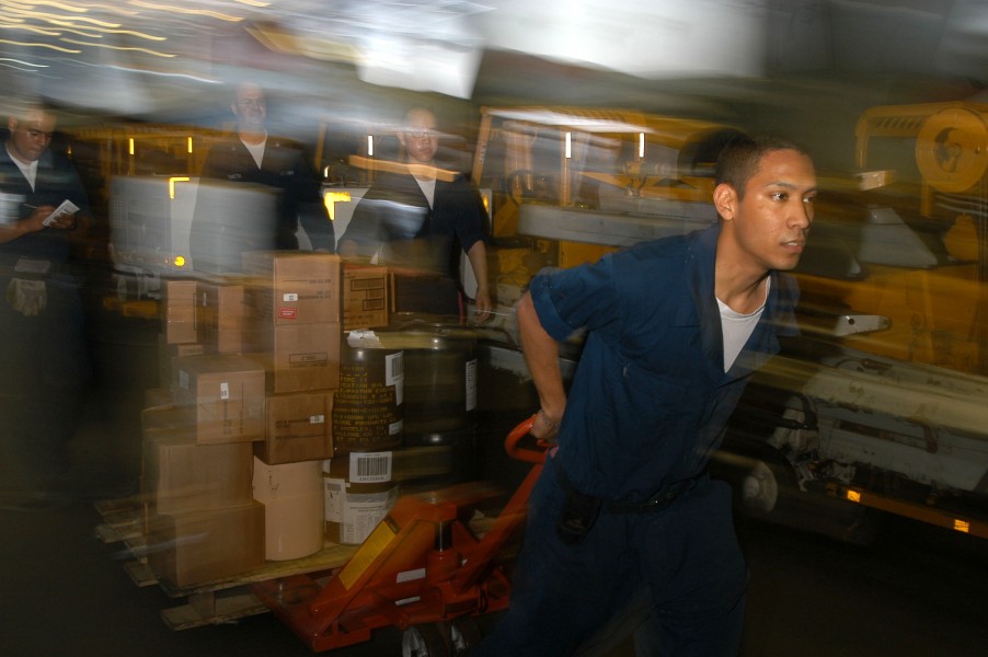 US Navy 040506-N-9047Q-002 Airman Michael Munoz moves Hazardous Material (HAZMAT) items through the hangar bay