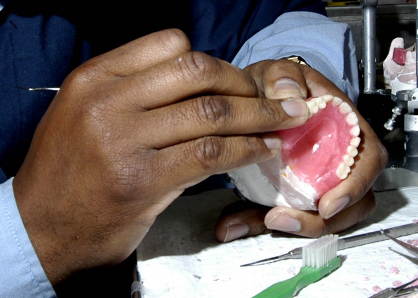US Navy 040617-N-0050T-003 Dental Technician 2nd Class Robert Willis, from Jacksonville, Fla., fabricates a set of dentures in the Dental Lab