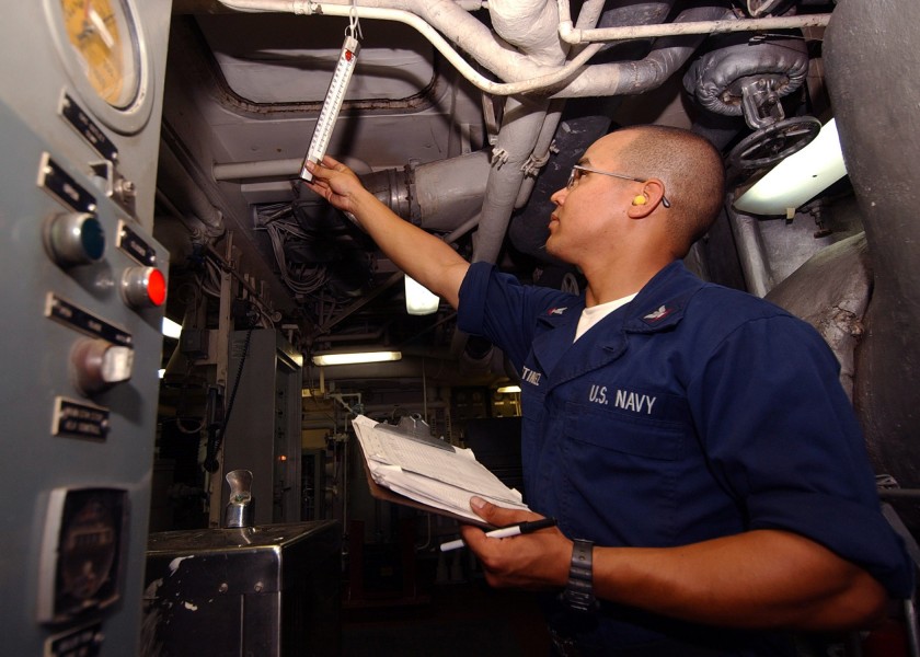 US Navy 040701-N-4374S-003 Engineman 3rd Class Carlos Martinez checks the temperature in main engine room two