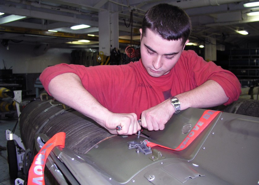 US Navy 040730-N-6387D-003 Aviation Ordanceman Airman Jonathan M. Bivens of Hillsboro, Ohio, builds bombs aboard the conventionally powered aircraft carrier USS John F. Kennedy (CV 67)