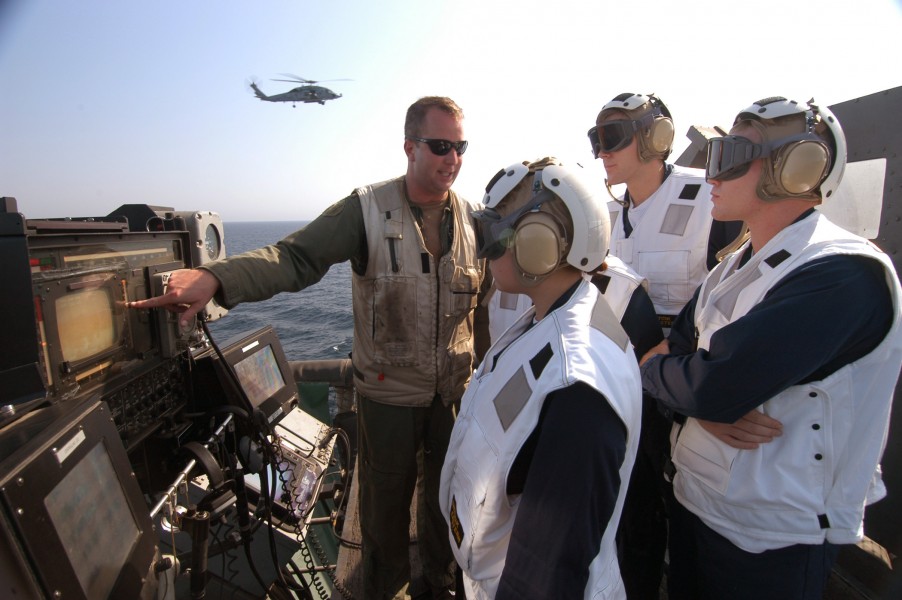 US Navy 040810-N-4190W-002 Lt. Cmdr. Garner Morgan explains the purpose of the Heads-up display on the LSO station to a group of Naval Reserve Officer Training Corps (NROTC) Midshipman