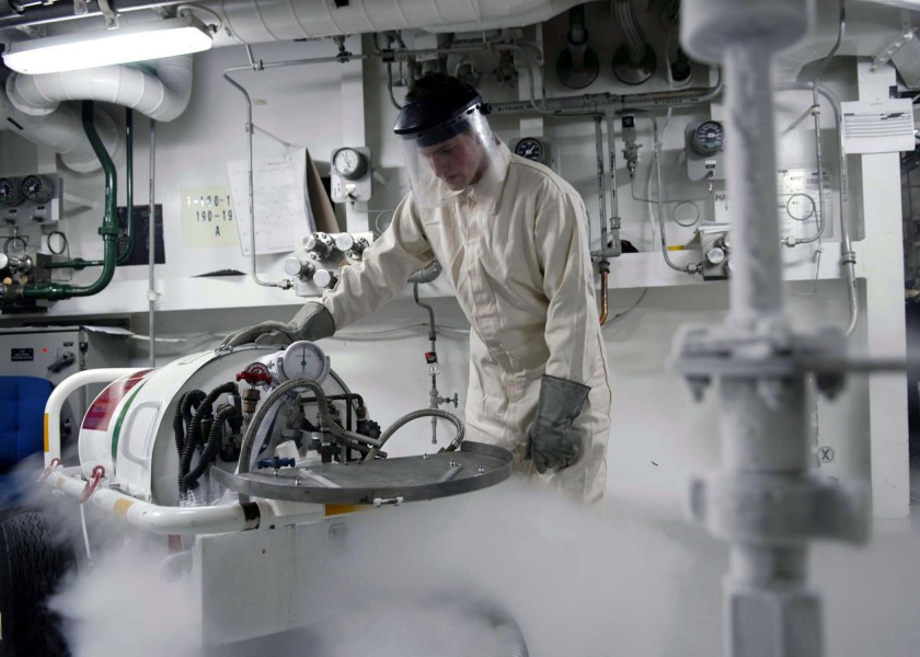 US Navy 040813-N-5362F-014 Machinist Mate 3rd Class Barry Biesen of Sitcka, Ark., assigned to the O2N2 Plant aboard aircraft carrier USS Abraham Lincoln (CVN 72), fills a liquid oxygen cart