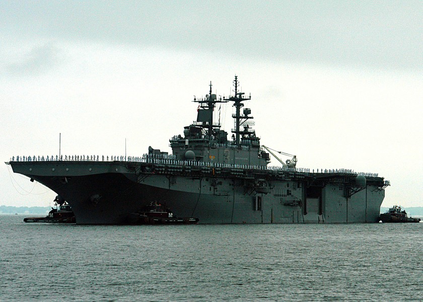 US Navy 040814-N-4048T-003 The amphibious assault ship USS Kearsarge (LHD-3) is guided by tugs as the ship pulls into Naval Station Norfolk