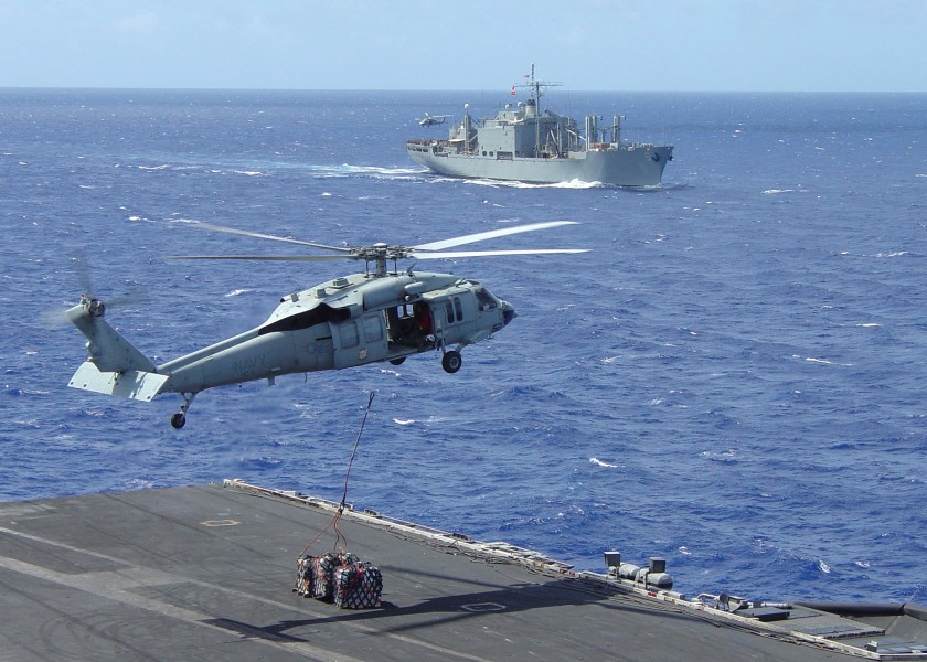 US Navy 040815-N-8828A-001 A MH-60S Knighthawk transports supplies from the Military Sealift Command (MSC) combat stores ship USNS Concord (TAFS 5) to the USS John C. Stennis (CVN 74)