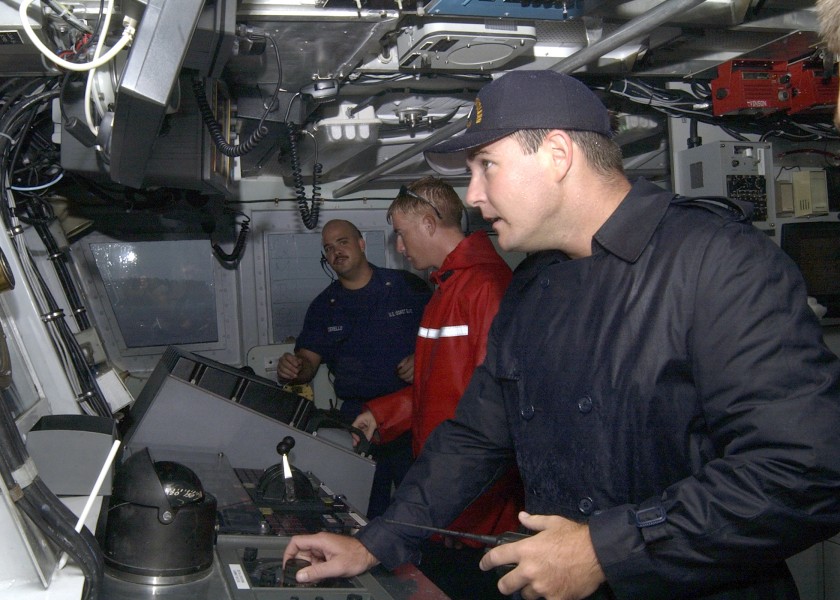 US Navy 040819-N-7293M-001 Lt. Jerome E. Dubay, Commanding Officer of the U.S. Coast Guard Cutter Galveston Island (WPB 1349), peers out of the bridge windows into a driving rain