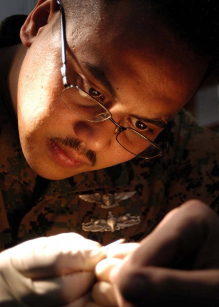 US Navy 040907-N-5384B-049 Hospital Corpsman 2nd Class John Espeleta performs a medical procedure on a crew member aboard the Nimitz-class aircraft carrier USS Abraham Lincoln (CVN 72)