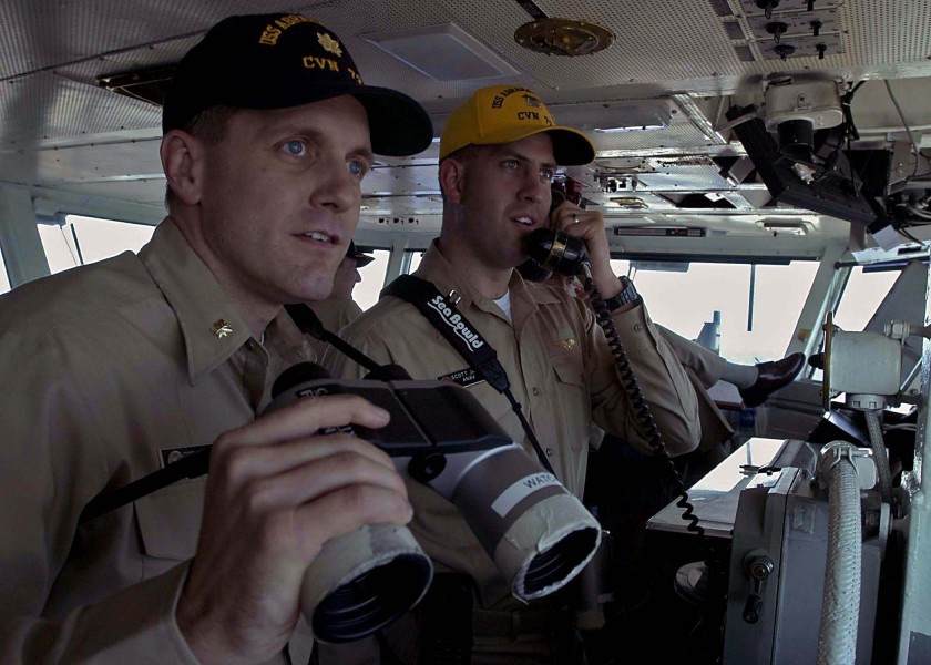 US Navy 041028-N-5384B-041 Lt. Cmdr. Brent House, left, and Lt. Scott Janick stands watch on the Bridge aboard the Nimitz-class aircraft carrier USS Abraham Lincoln (CVN 72)