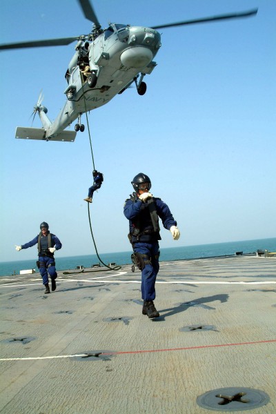 US Navy 041104-N-4772B-058 Boarding team members from the Royal Australian guided missile frigate HMAS Adelaide (FFG 01) conduct a fast rope exercise from an Australian S-70B-2 Seahawk