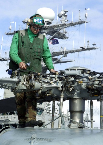 US Navy 041113-N-6817C-100 An Aviation Machinists Mate performs final maintenance prior to the flight of an SH-60B Seahawk