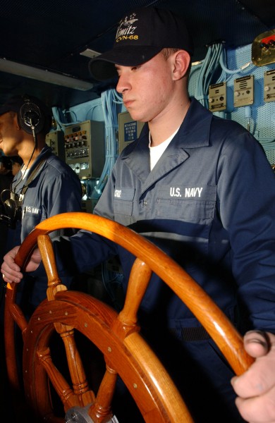 US Navy 041206-N-0413R-021 Boatswain^rsquo,s Mate Seaman Glenn Cruz of Camden, N.J., stands the helm watch, during flight operations aboard the aircraft carrier USS Nimitz (CVN 68)