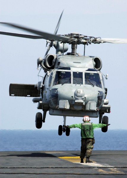US Navy 050105-N-4166B-086 An SH-60B Seahawk helicopter lands on the flight deck aboard USS Abraham Lincoln (CVN 72) to pick up jugs of purified water