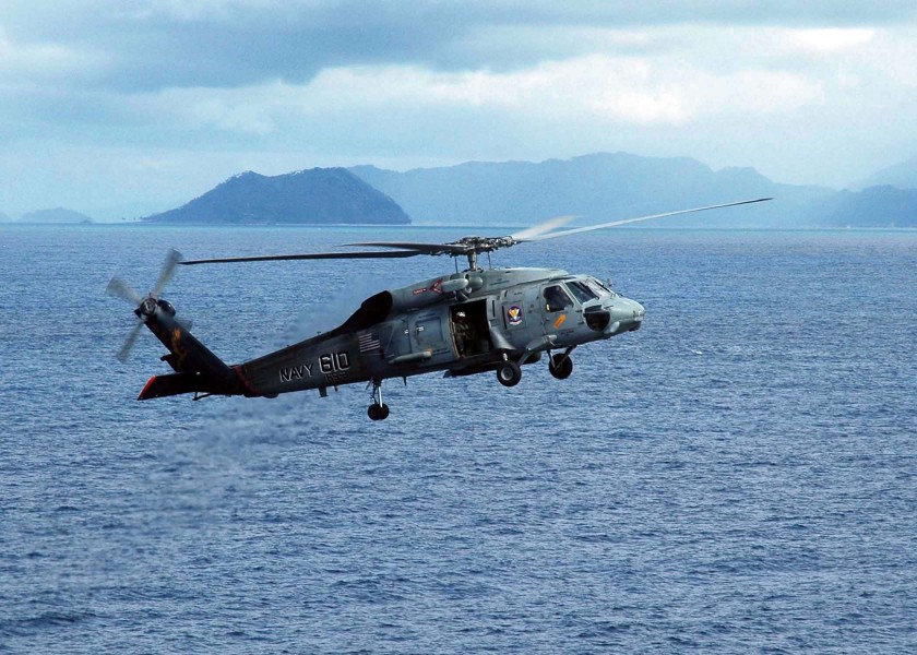 US Navy 050109-N-9293K-014 An SH-60F Seahawk helicopter prepares to land on the flight deck aboard USS Abraham Lincoln (CVN 72) to pick up water for victims of the Tsunami