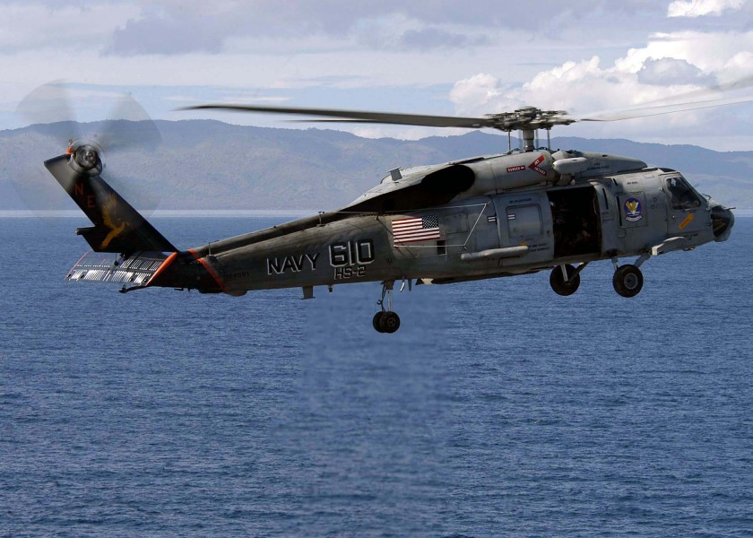 US Navy 050111-N-9079D-167 An SH-60F Seahawk helicopter heads to Sultan Iskandar Muda Air Force Base in Banda Aceh, Sumatra, Indonesia with water and relief supplies