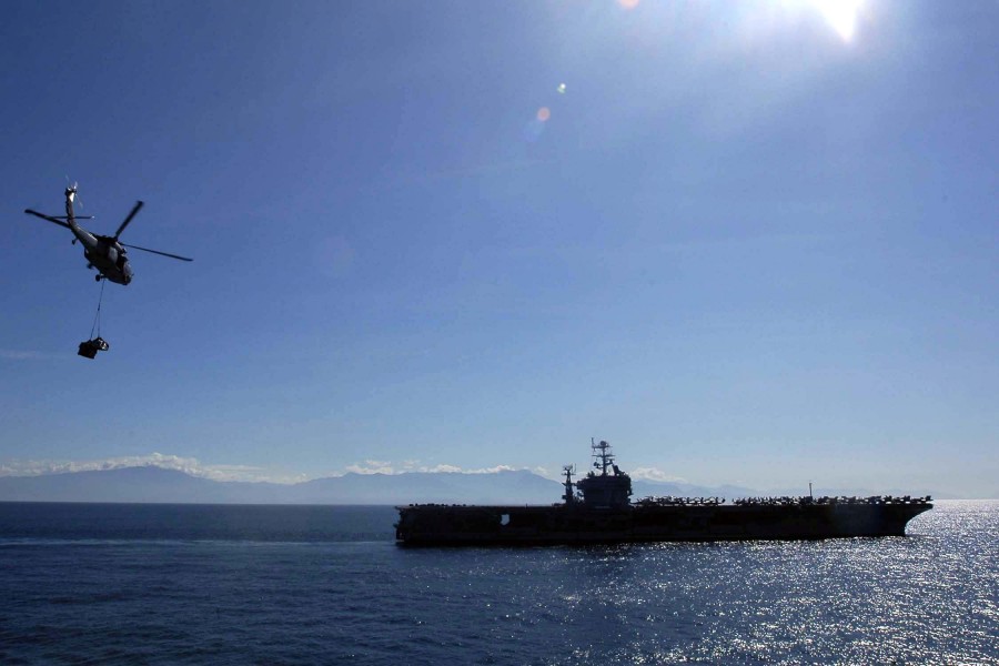 US Navy 050114-N-6074Y-044 An MH-60S Knighthawk helicopter transports cargo pallets to the Nimitz-class aircraft carrier USS Abraham Lincoln (CVN 72) during a vertical replenishment