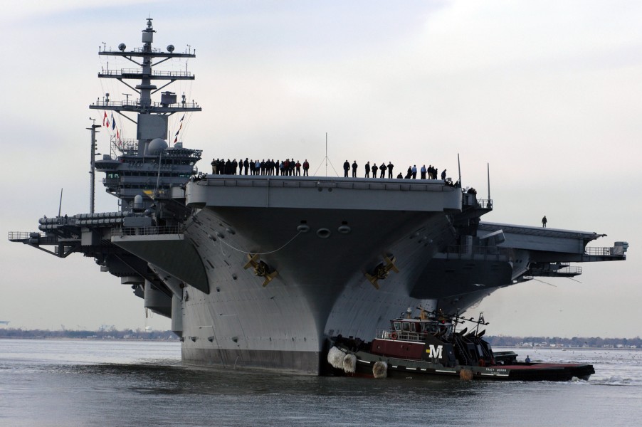 US Navy 050125-N-9600H-123 Sailors watch from the flight deck of USS Dwight D. Eisenhower (CVN 69) during her arrival at Naval Station Norfolk, Va