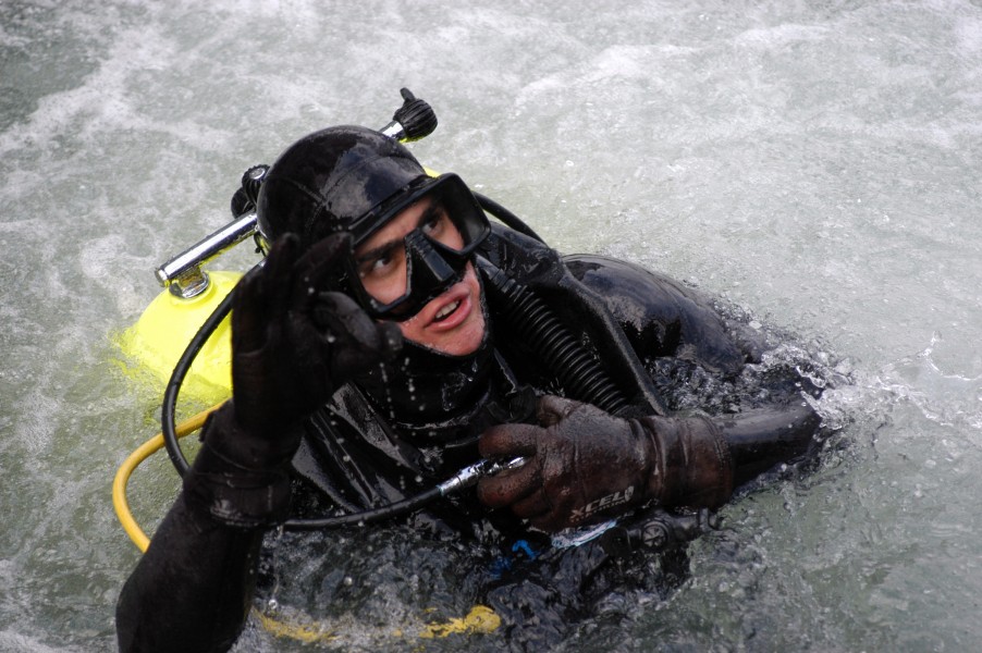 US Navy 050202-N-3390M-266 Aviation Maintenance Administrationman 2nd Class Jesus Lopez gives an OK signal to dive supervisors during diving proficiency training on board Naval Station Everett