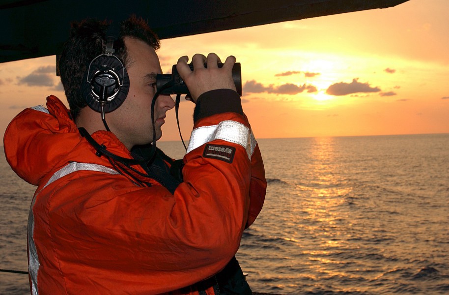 US Navy 050420-N-1205W-001 A Sailor assigned to the Deck Department aboard USS John F. Kennedy (CV 67), stands aft port look watch prior to a replenishment at sea in the Atlantic Ocean