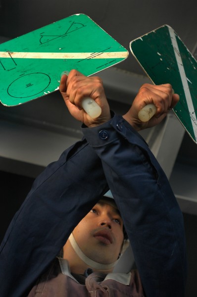 US Navy 050617-N-1332Y-081 Seaman Francis Deguzman from Toms River, N.J., signals that all lines have been detached following a replenishment at sea 