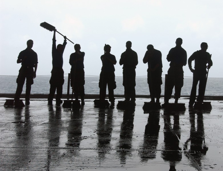 US Navy 050710-N-5248R-005 Sailors use brushes to scrub down the deck on the hangar bay during a Scrub Exercise (SCRUBEX) aboard the Nimitz-class aircraft carrier USS Theodore Roosevelt (CVN 71)