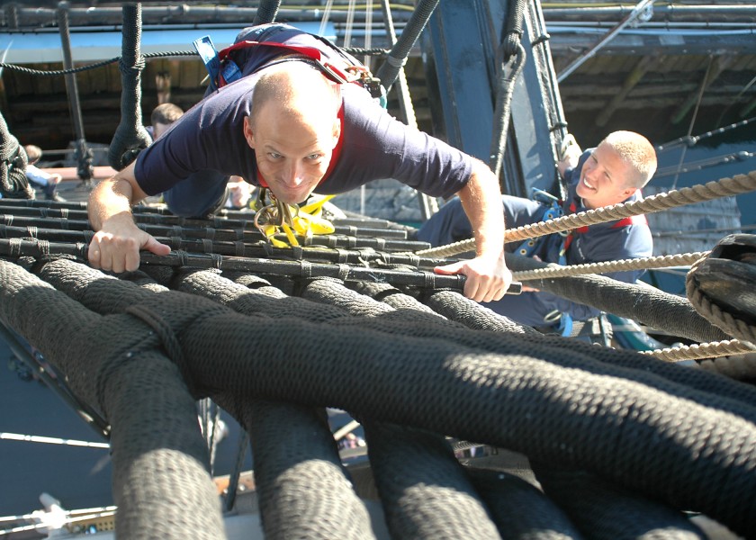 US Navy 050823-N-0335C-001 A chief petty officer (CPO) selectee climbs the rigging of the foremast of USS Constitution during sail training