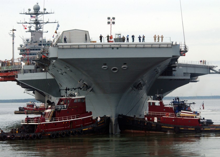 US Navy 050830-N-5188B-022 Two tug boats steady the bow of the Nimitz Class aircraft carrier USS George Washington (CVN 73) as the nuclear-powered ship transits from the dry dock